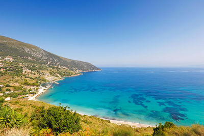 Scenic view of sea against clear blue sky