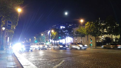 Illuminated city street at night