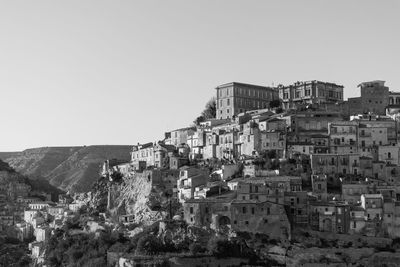 Buildings in city against clear sky