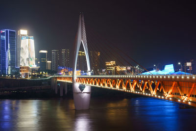 View of bridge over river at night