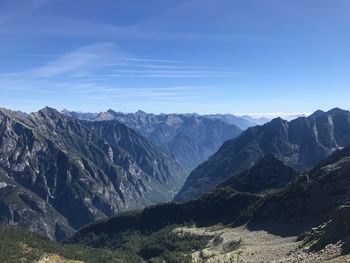 Scenic view of mountains against blue sky