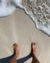 Feet on sand at trancoso bahia brazil 