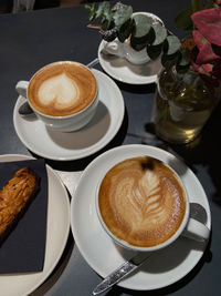 Coffee time - cappuccino, cake and flowers for the perfect joiful moment 