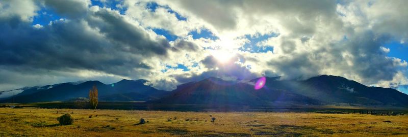 Scenic view of mountains against cloudy sky