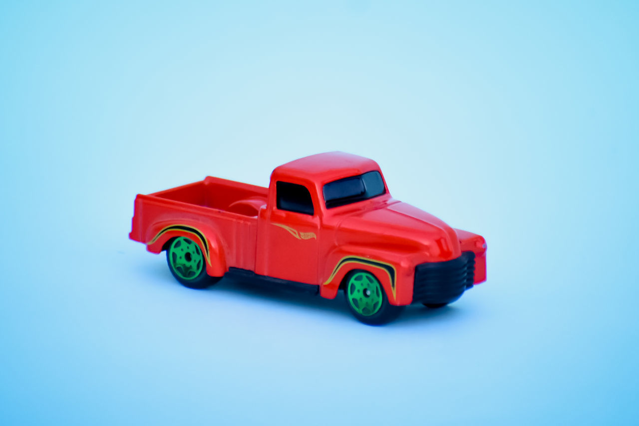 TOY CAR ON BLUE BACKGROUND