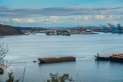 Clouds cover mount rainier with the port of tacoma in the foreground.