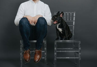 Man with dog sitting on chair