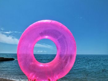 View of pink sea against blue sky