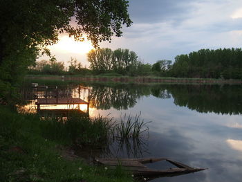 Scenic view of lake against sky at sunset