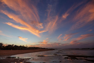 Scenic view of beach against sky during sunset