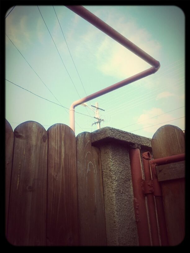 transfer print, low angle view, built structure, auto post production filter, architecture, sky, building exterior, power line, cloud, electricity, cable, no people, house, outdoors, fuel and power generation, power supply, cloud - sky, connection, sunlight, day