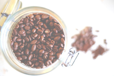 High angle view of roasted coffee beans on white background