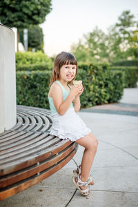 Portrait of smiling girl sitting outdoors