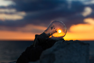 Close-up of sea against sky during sunset