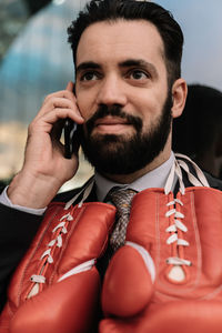 Portrait of young man holding smart phone