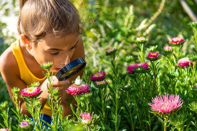 Side view of boy blowing flowers