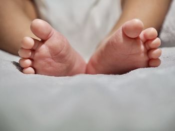 Close-up of baby feet on bed