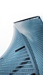 Low angle view of modern glass building against sky