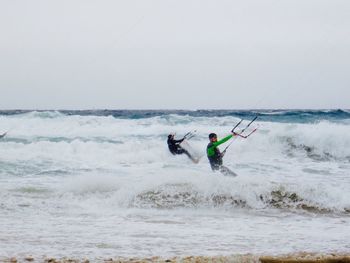 People windsurfing in sea