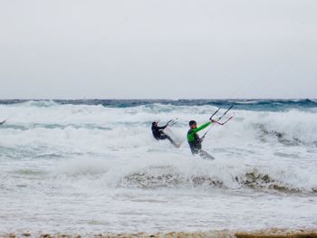 People surfing in sea