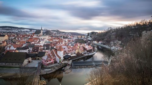 High angle view of river amidst buildings against sky