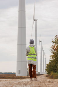 Rear view of man standing against sky