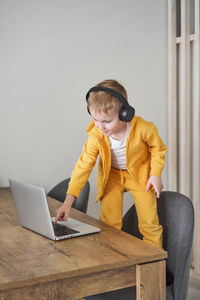 Man using mobile phone while sitting on table