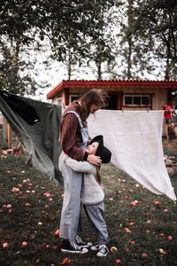 Mother and daughter embracing at yard