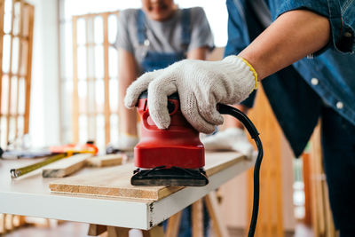 Midsection of man working in workshop