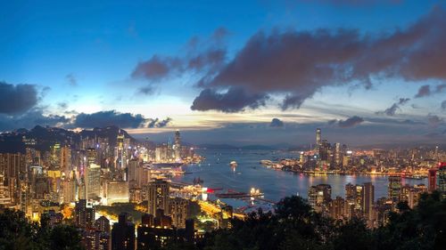 Aerial view of illuminated city against sky at night