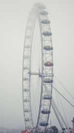 Low angle view of ferris wheel against sky