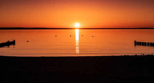 Scenic view of sea against romantic sky at sunset