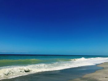 Scenic view of sea against clear blue sky