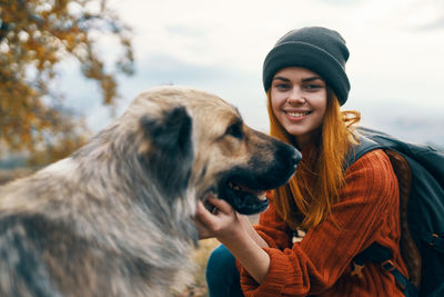 Portrait of smiling young woman with dog