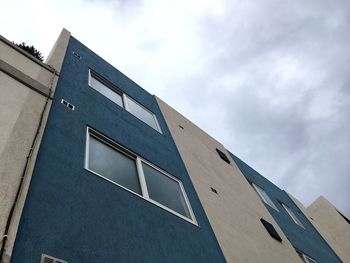 Low angle view of building against cloudy sky