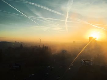 Aerial view of cityscape against sky during sunset