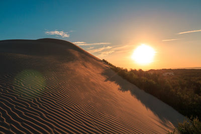 Scenic view of field against sky during sunset