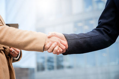 Cropped image of business people shaking hand