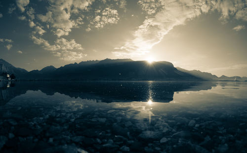 Scenic view of lake against dramatic sky