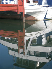 Sailboats moored at harbor against sky