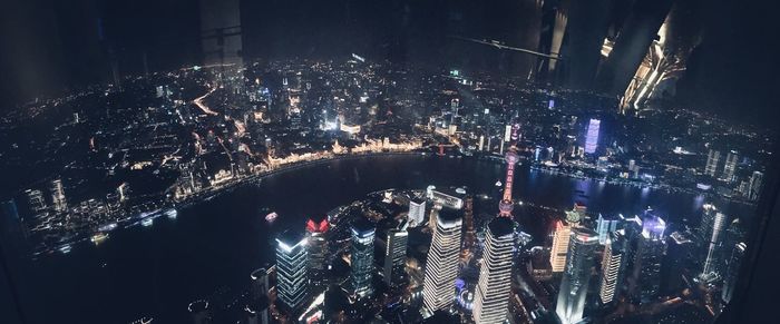 High angle view of city lit up at night