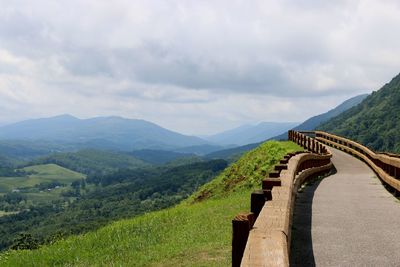 Scenic view of mountain range against cloudy sky