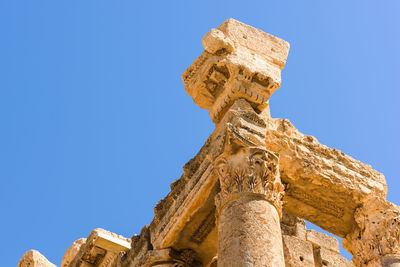 Low angle view of statue against clear blue sky