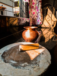 Close-up of burning candles on cutting board