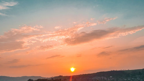 Scenic view of silhouette mountains against sky during sunset