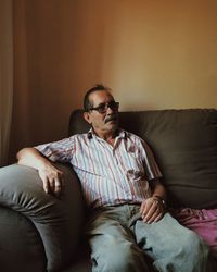 Man sitting on sofa at home