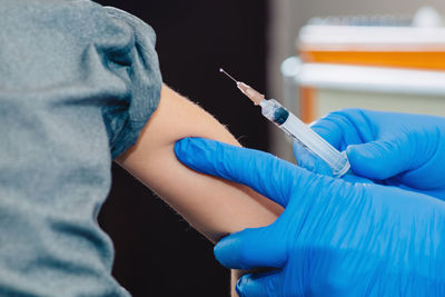 Close-up of doctor giving injection to patient