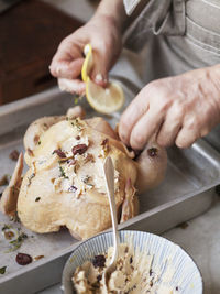 Woman preparing chicken for roast, close-up