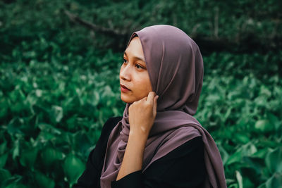 Portrait of young woman looking away