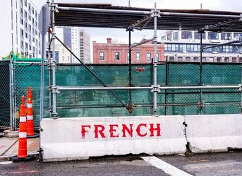 Information sign by building in city
